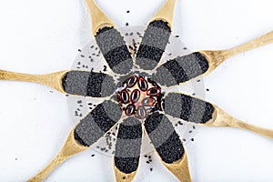 Black cumin oil pill. Black cumin or black caraway spicy seeds in wood spoon isolated on white background. Nigella sativa also