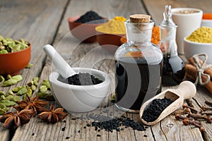 Black cumin or roman coriander seeds, black caraway oil bottles and aromatic spices. Ingredients for cooking. Ayurveda tr