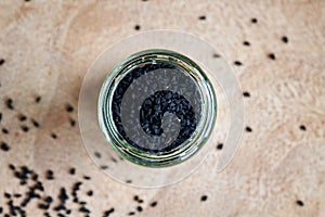 Black cumin seeds in a jar, top view