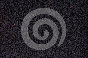 Black cumin seeds, Nigella sativa - closeup background.