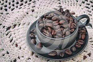 Black cup with coffee beans