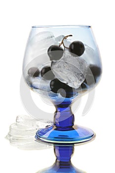 Black currant in the wineglass with an ice