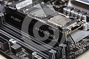 Black DDR 4 DIMM 16 Gb Kingston HyperX Fury Memory RAM Module in the slot on the motherboard Asus closeup