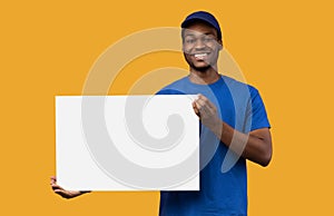 Black delivery man holding blank white advertising board