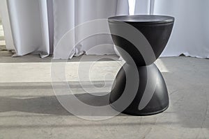 black designer chair in the shape of an hourglass