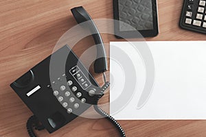 The black desktop telephone on the table. phone on desk in office.