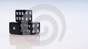 Black dice with white dots isolated on white background.