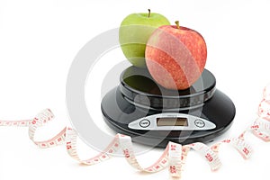 Black digital scale, weight green apple