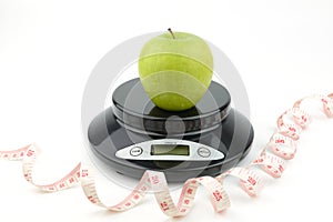 Black digital scale, weight green apple