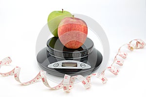 Black digital scale, weight green apple