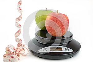 Black digital scale, weight green apple