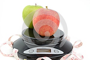 Black digital scale, weight green apple