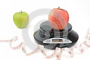 Black digital scale, weight green apple