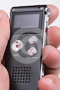 Black digital voice recorder in hand