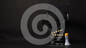 Black Director chair and yellow clapper board or Clapperboard or movie slate with megaphone .it use in video production or film