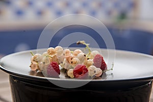 Black dish with freshly  sweet berries