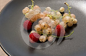 Black dish with freshly  sweet berries