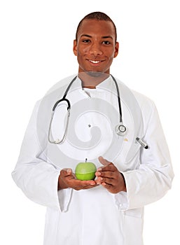Black doctor holding green apple