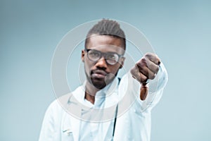 Black doctor\'s thumbs-down disapproves unscientific choices photo
