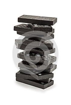 Black dominoes stacked in a tower.