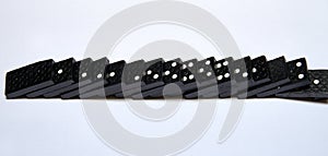 Black dominos in chain on white background