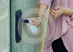 A woman suffering germophobia presses dirty door handle photo