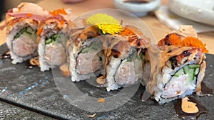 BLACK DRAGON ROLL Crabmeat, Avocado, Kappa Inside with Unagi, Avocado, Fish Flakes and Fish