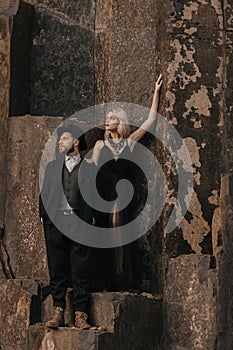 Black dressed wedding couple in rock. In love concept. Newly weds happy couple celebrating love.