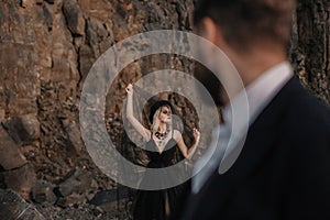 Black dressed wedding couple in rock. In love concept. Newly weds happy couple celebrating love.
