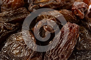 Black dried raisins background. Raisins as background