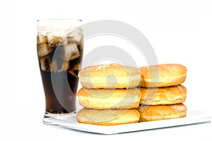 Black drink (cola) and donuts and sugar over lettuce over white