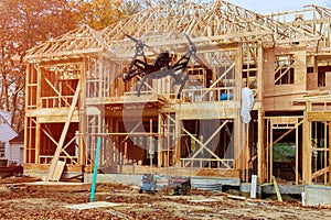 Black drone quadcopter with camera flying over Family Home Construction - Building a New Wood Framed House