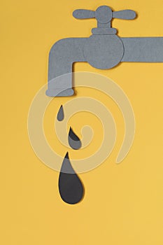 Black drop dripping from tap. Oil concept.