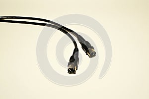 Black audio cable on white background