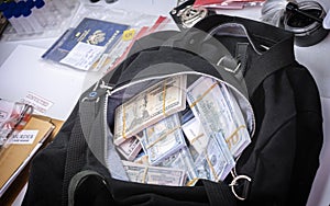 Black duffel bag full of dollar notes in criminal investigation unit