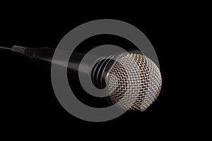 Black dynamic microphone on a dark background