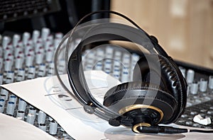 Black earphones on a console in a recording studio