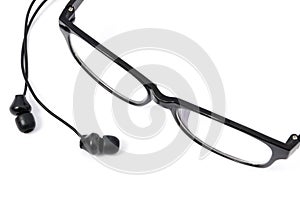 Black earphones and eyeglasses