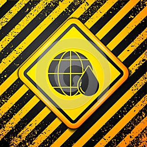 Black Earth planet in water drop icon isolated on yellow background. World globe. Saving water and world environmental