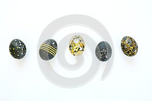 Black easter eggs with gold pattern on white