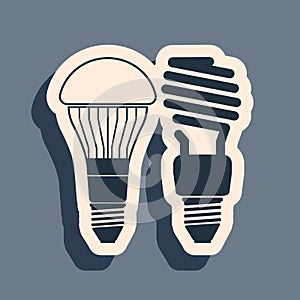 Black Economical LED illuminated lightbulb and fluorescent light bulb icon isolated on grey background. Save energy lamp