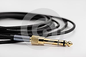 Black elastic wire, cable with plug and adapter, close-up.