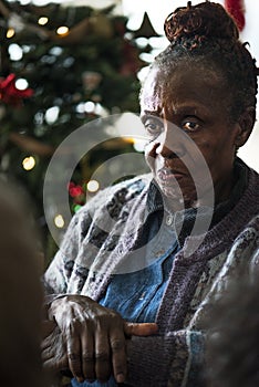 A black elderly woman in Chrismas holiday photo