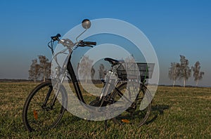 Black electric bike on ski slope in Budweis city with windy trees
