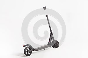 Black electric kick scooter on white background, rear view