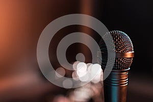 Black electric microphone on empty stage