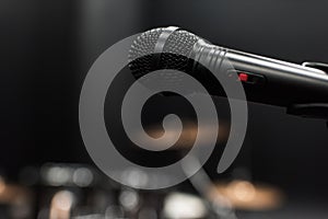 Black electric microphone on empty stage