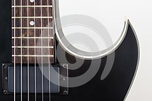 Black electric rock guitar with humbucker pickup close up macro shot