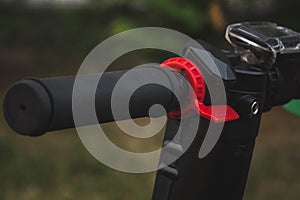 black electric scooter standing on the rubber pad in the park, steering wheel view