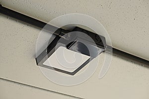Black electrical conduit for cable routing electrical with led at bottom of upper floor.